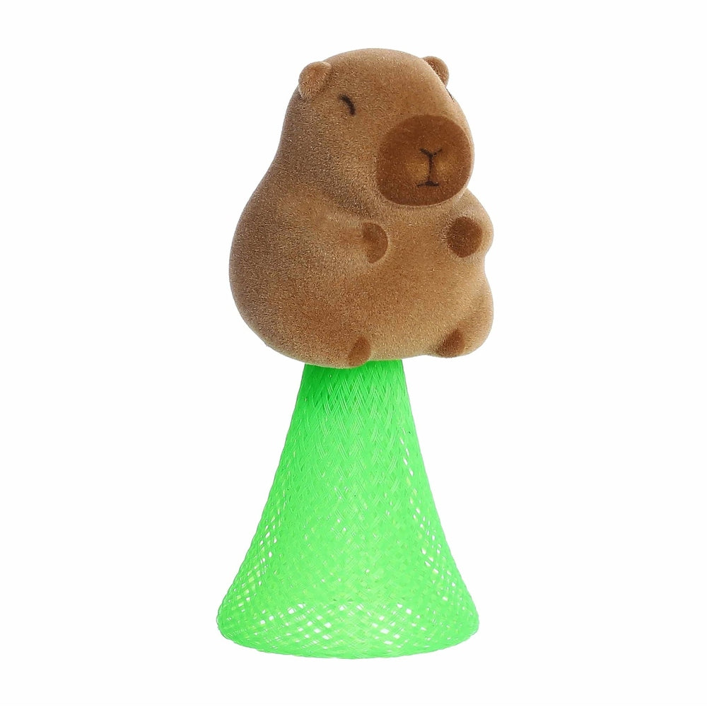 Aurora Toys Capybara Poppers 4" plush perched on a bright green mesh stand, ready for cuddle play.