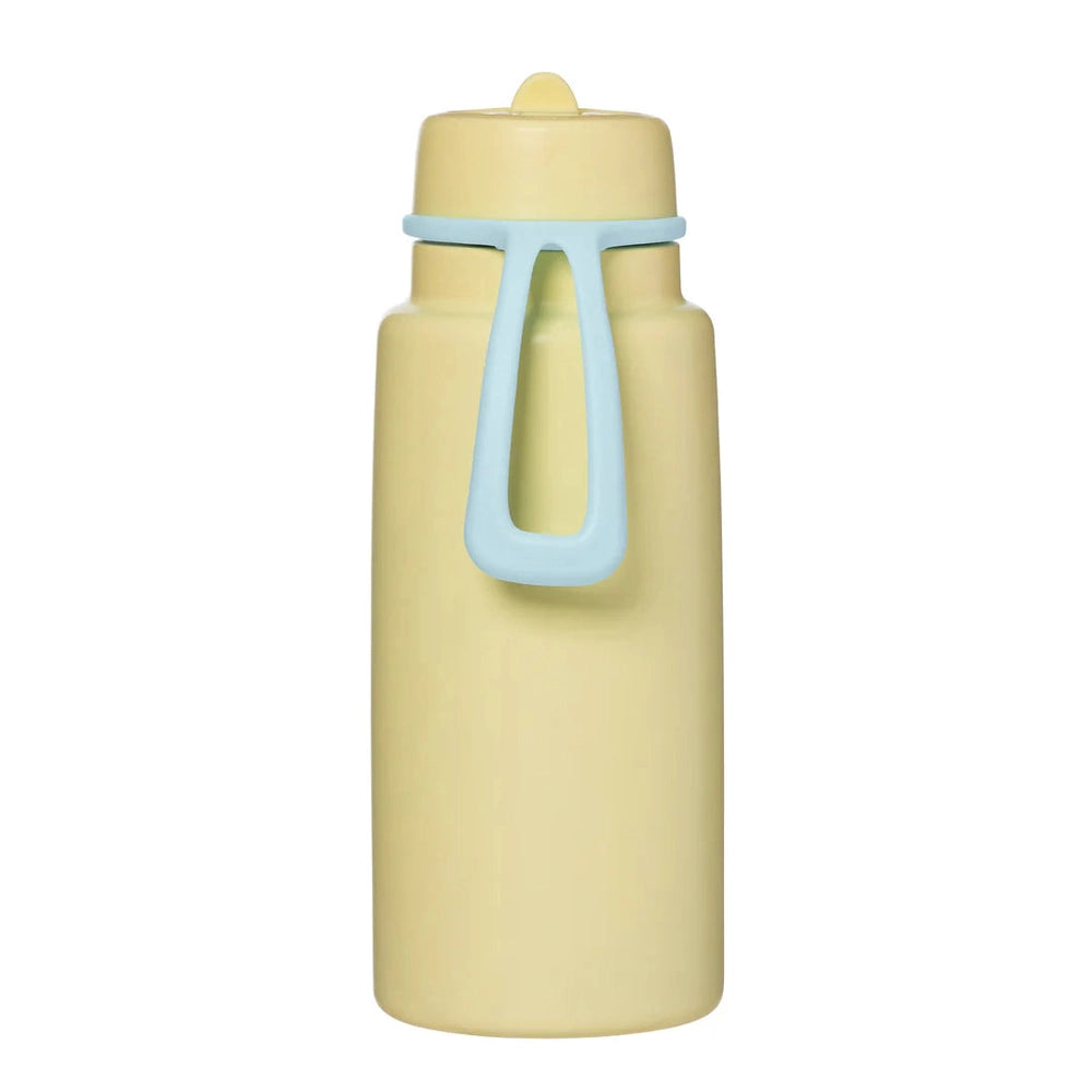 B.BOX Insulated Flip Top 1L water bottle in pale yellow with a blue carry handle; strap grips the bottle for easy carrying