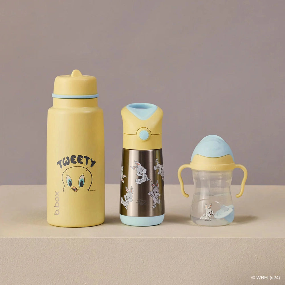 B.box Insulated Flip Top 1L bottle set in pastel yellow with blue lid, showing the flip-top lid and kid-friendly sippy cup handles.