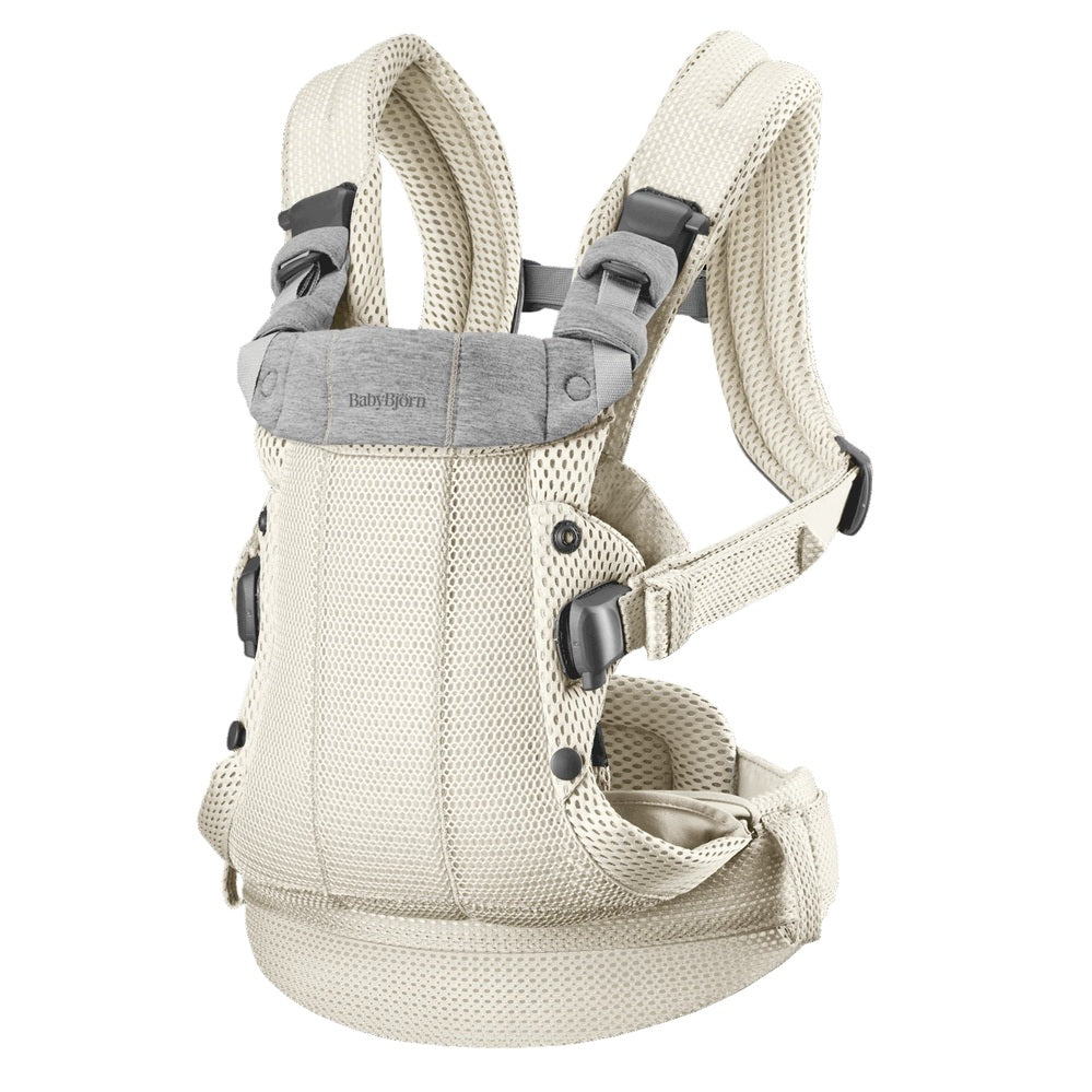 BabyBjörn Harmony baby carrier in beige with padded straps and breathable mesh, shown ready to wear.