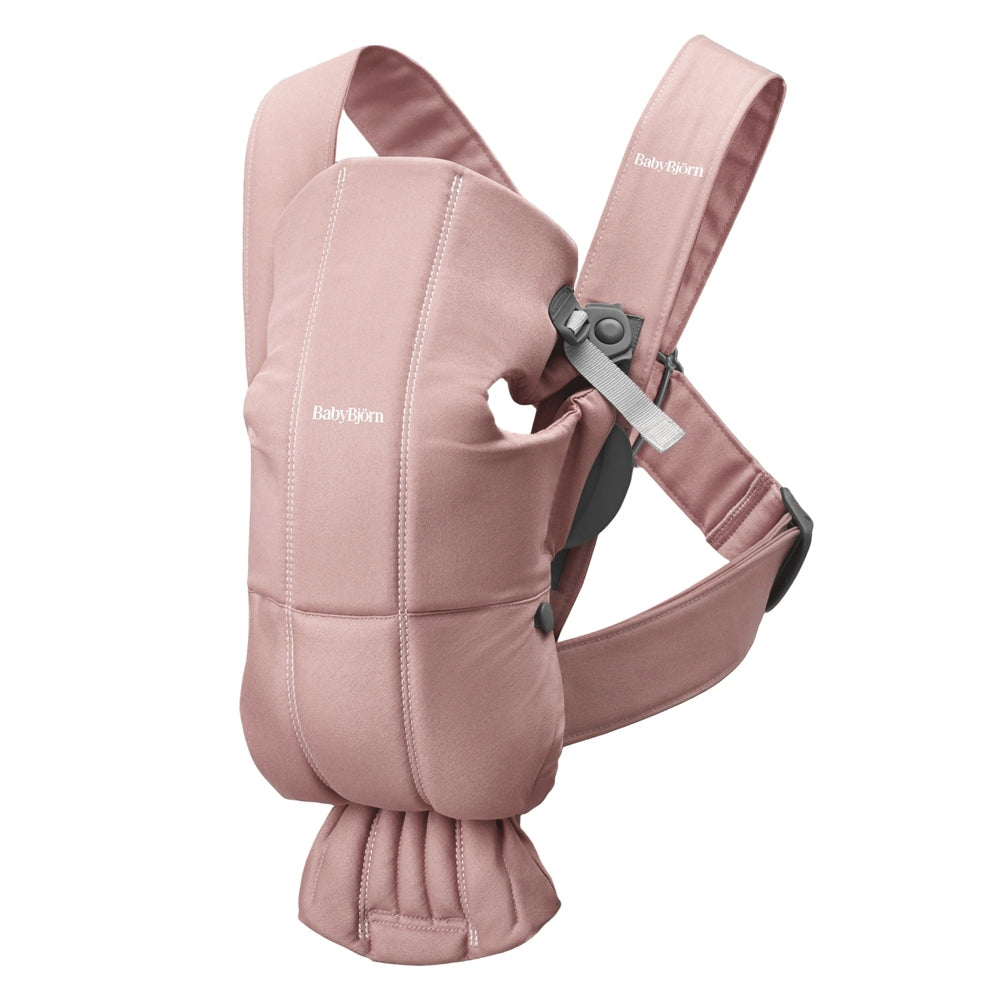 BabyBjörn Baby Carrier Mini in dusty pink with padded seat and adjustable straps, waist belt visible.