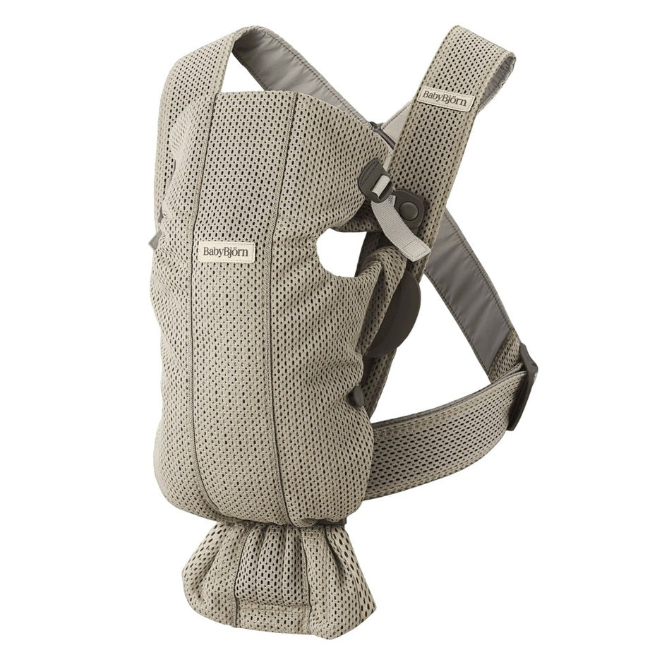 BabyBjörn Baby Carrier Mini in beige mesh, featuring padded straps and adjustable buckles ready to wear.