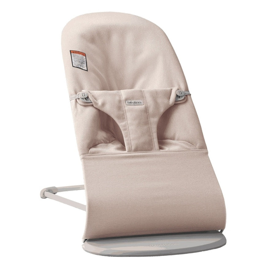 BabyBjörn Bouncer Bliss beige fabric baby bouncer resting on its curved base with padded seat and safety harness.