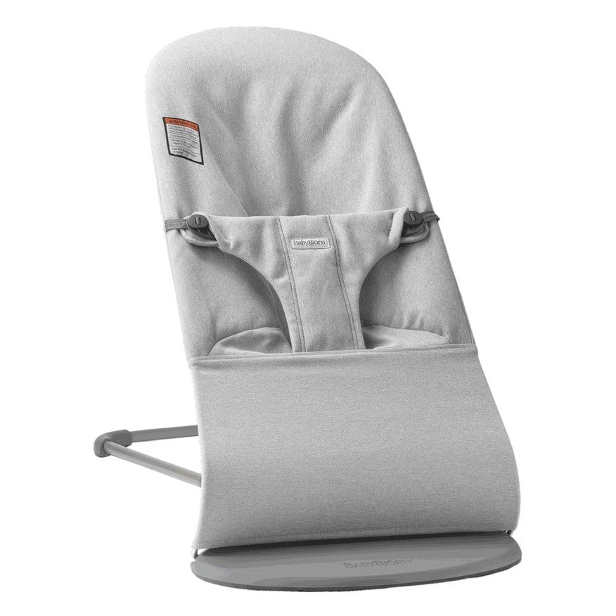 BabyBjörn Bouncer Bliss in light gray fabric with safety harness and curved rocking base.
