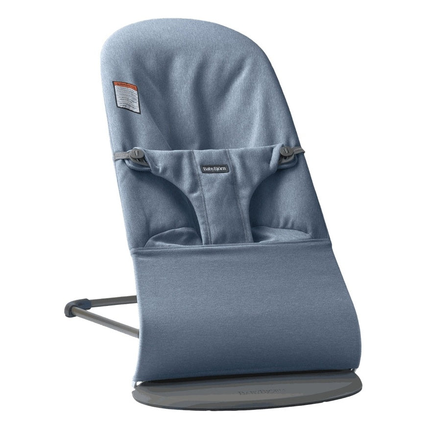 BabyBjörn Bouncer Bliss blue fabric infant bouncer secured to a sturdy gray frame with safety harness.
