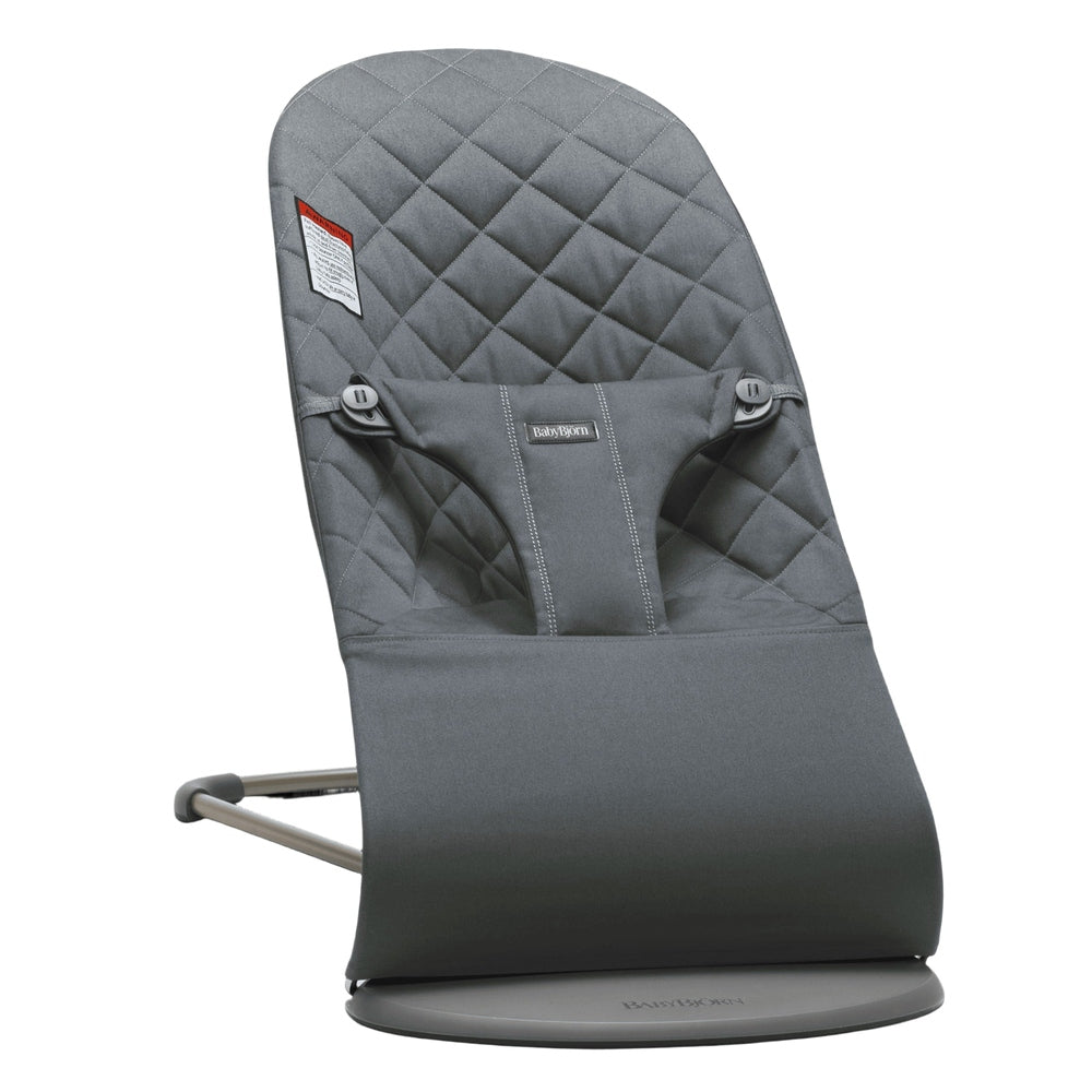 BabyBjörn Bouncer Bliss in gray with quilted back, supportive seat on a round base stand.