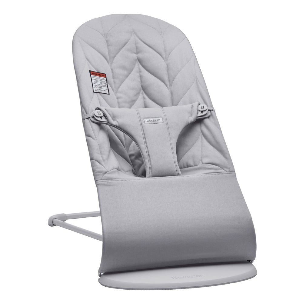 BabyBjörn Bouncer Bliss in gray with padded seat and 3-point harness on a round base for gentle rocking.