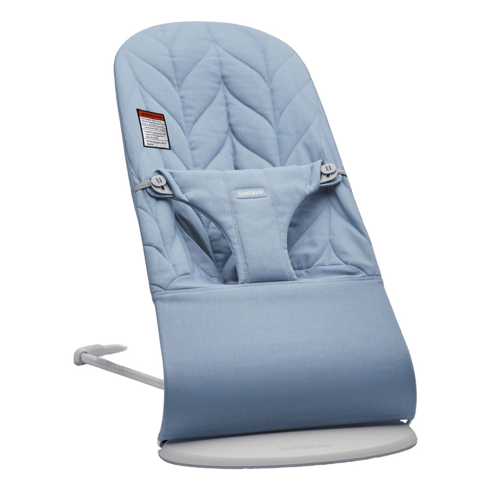 BabyBjörn Bouncer Bliss blue quilted seat on a white base, demonstrating the gentle rocking motion.
