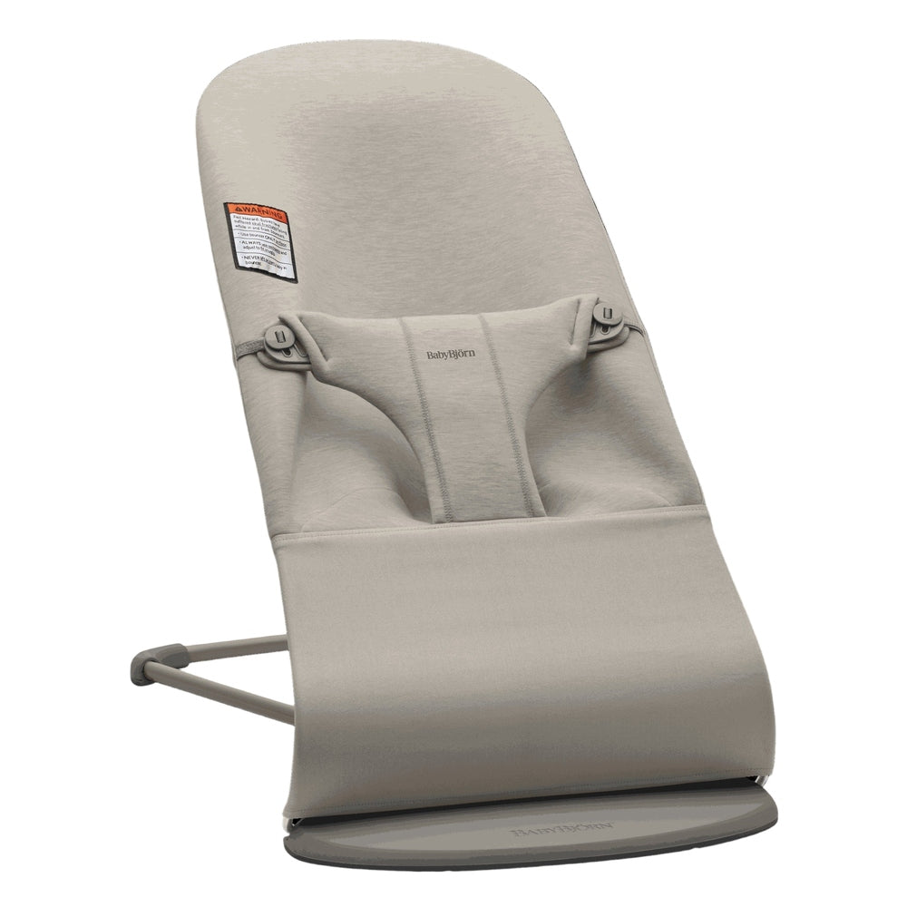BabyBjörn Bouncer Bliss in beige, soft fabric with harness, resting on its round circular base.