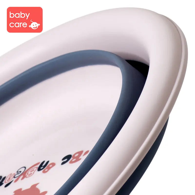 BC Babycare Foldable Baby Washbasin in white with blue rim shown for easy bath time