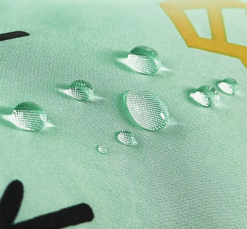 Bc Babycare Long Sleeve Bib in mint green fabric with water droplets beading on the sleeve.