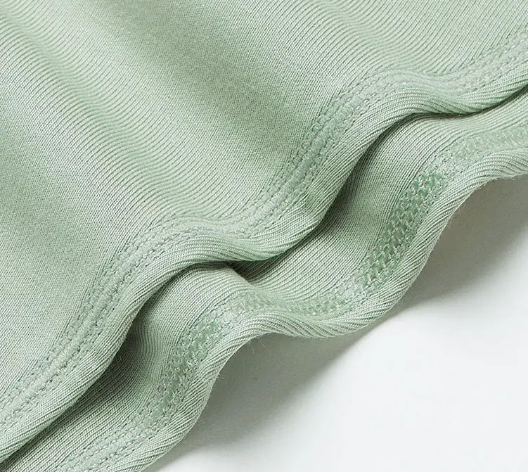BC Babycare Modal Sleepsuit Green, soft modal fabric with stitched seams shown folded.
