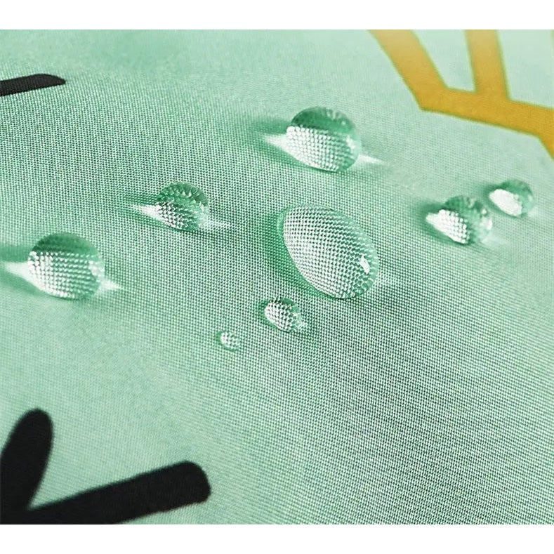 BC Babycare Waterproof Arm Sleeve in mint green; water beads on fabric, proving waterproof during mealtime.