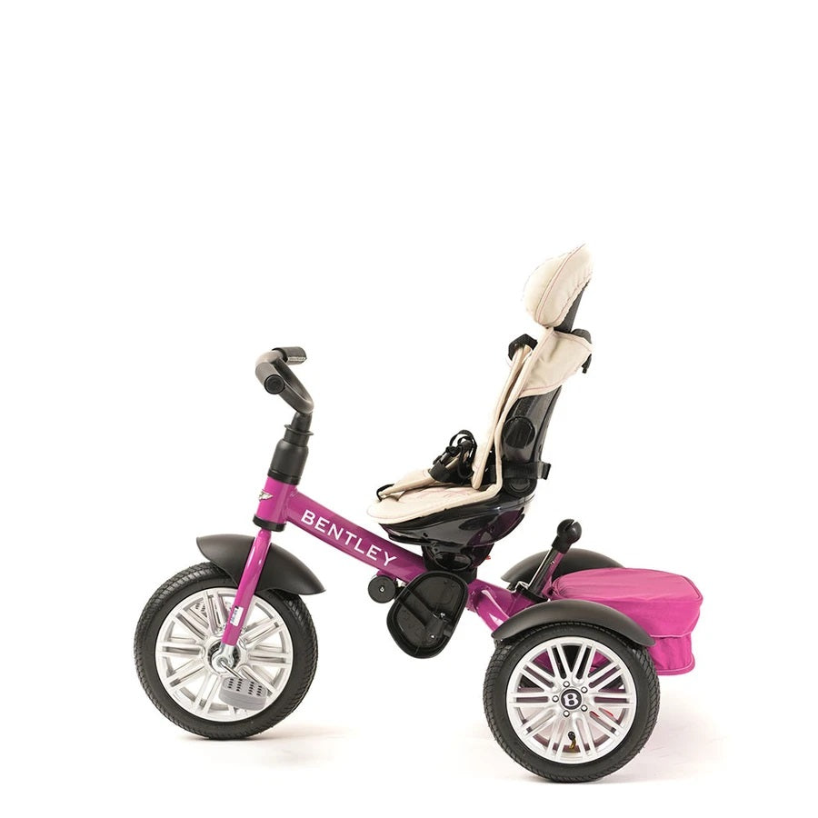 Bentley Trike 6-In-1 V2 in fuchsia pink with beige padded seat and rear storage bag, ready for ride.