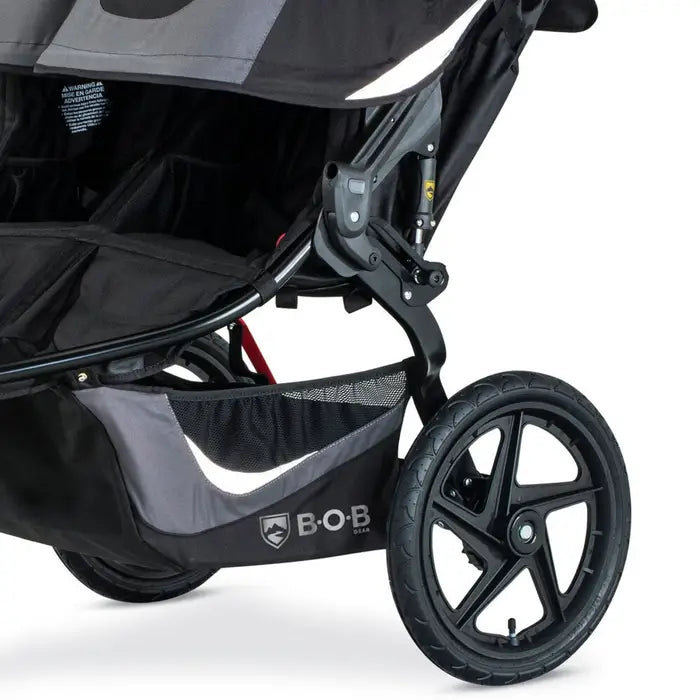 Bob Revolution Flex 3.0 Duallie Stroller, black double stroller with sturdy frame and under-seat storage basket.