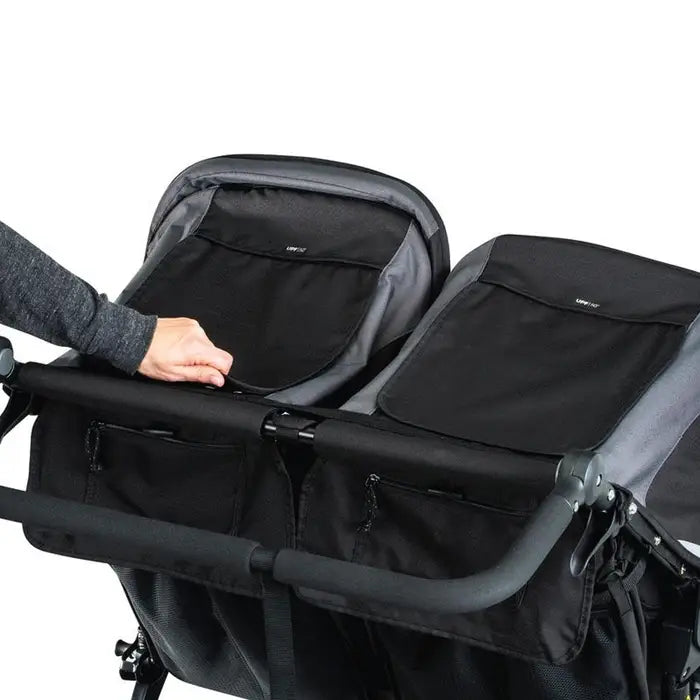 Bob Revolution Flex 3.0 Duallie Stroller, dual black seats, hand opens storage pocket between seats.