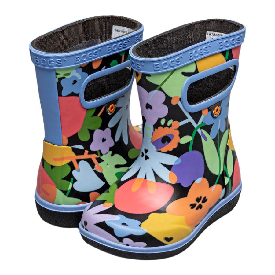 BOGS Skipper II Overlap Flowers Black Multi toddler boots on a toddler's feet, blue trim, colorful floral print.