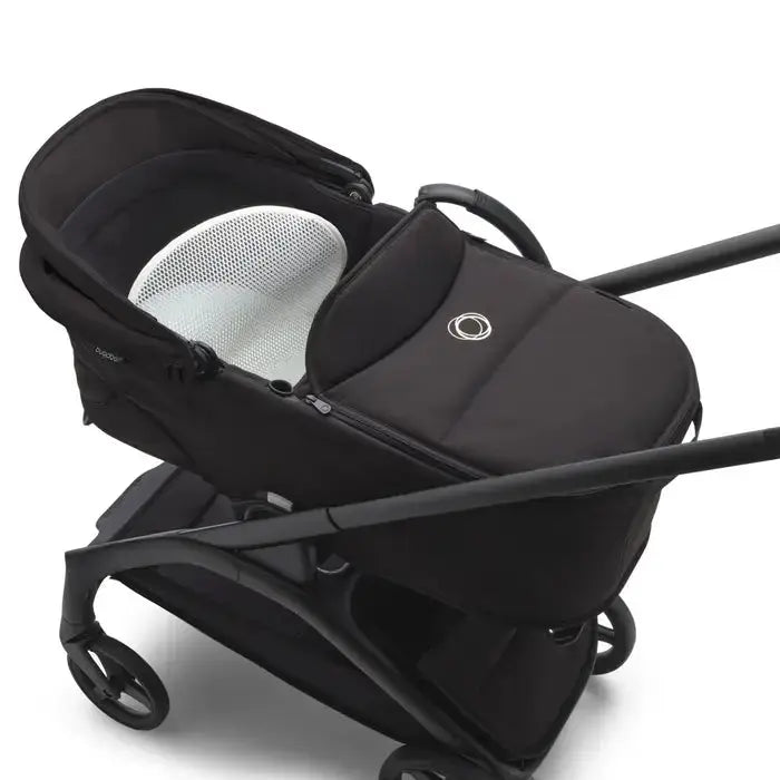 Bugaboo Dragonfly pram body complete in black with white mesh interior, attached to stroller for newborn transport.