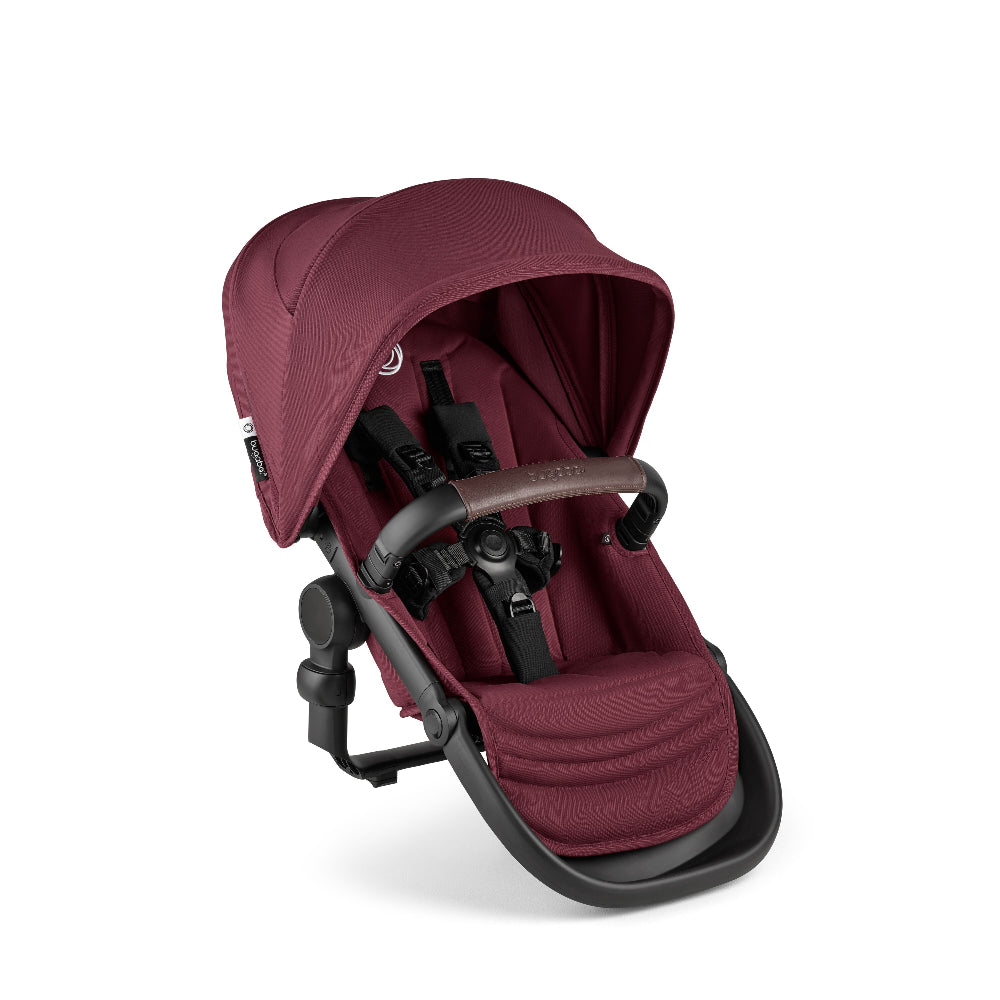 Bugaboo Kangaroo Sibling Seat in burgundy fabric, secured with a 5-point harness on a black frame.