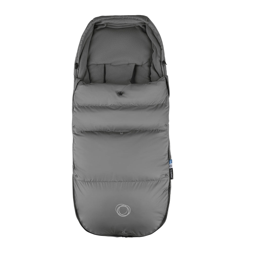 Bugaboo THERMOLITE® Performance Footmuff in gray, snugly attached to a stroller to keep baby warm on winter walks.