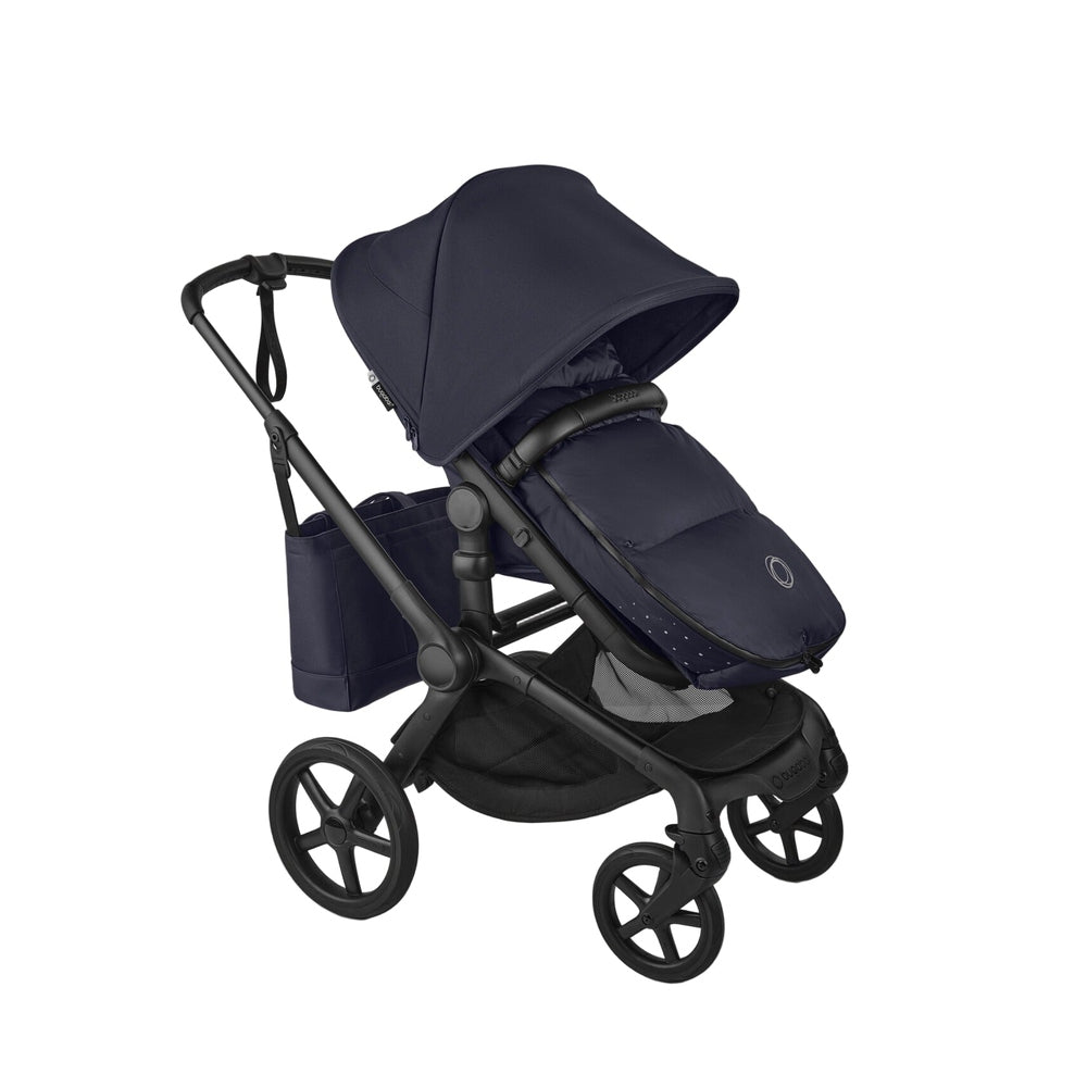 Bugaboo THERMOLITE® Performance Footmuff in navy, zipped to a stroller seat for warm winter strolls.
