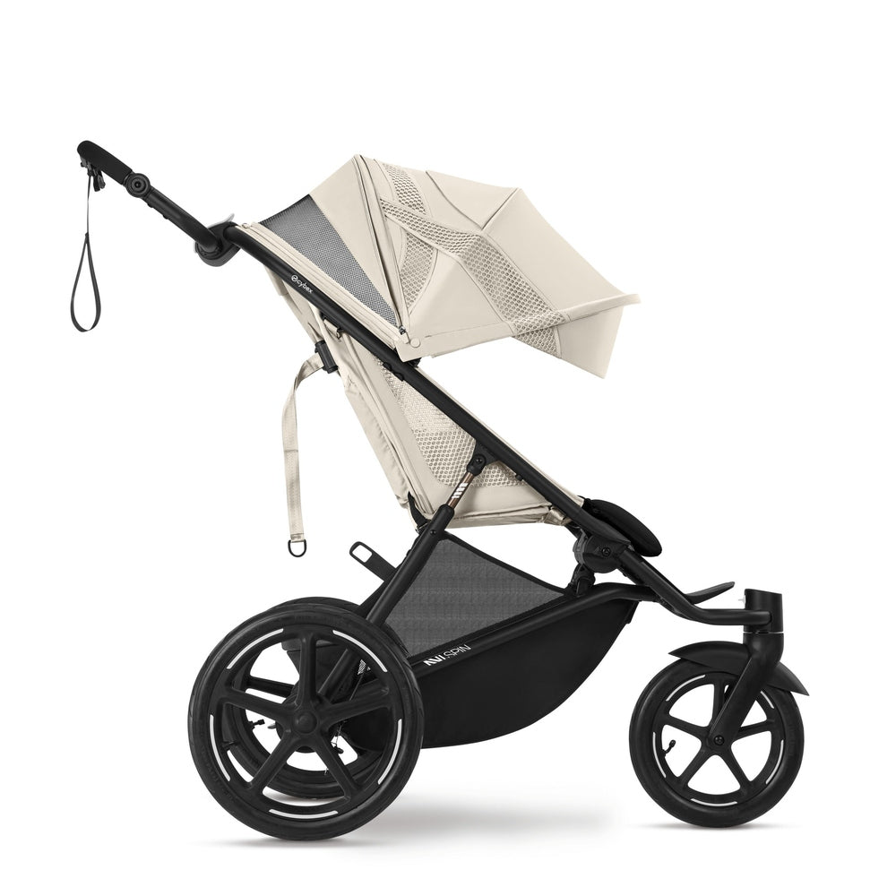 CYBEX Avi Spin All Terrain Stroller in beige with black frame, large wheels, and extendable canopy.