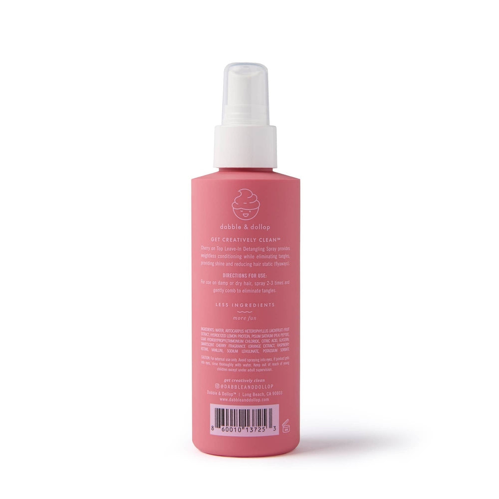 Dabble & Dollop Hair Detangling & Conditioning Spray Cherry on Top bottle spraying to detangle hair.