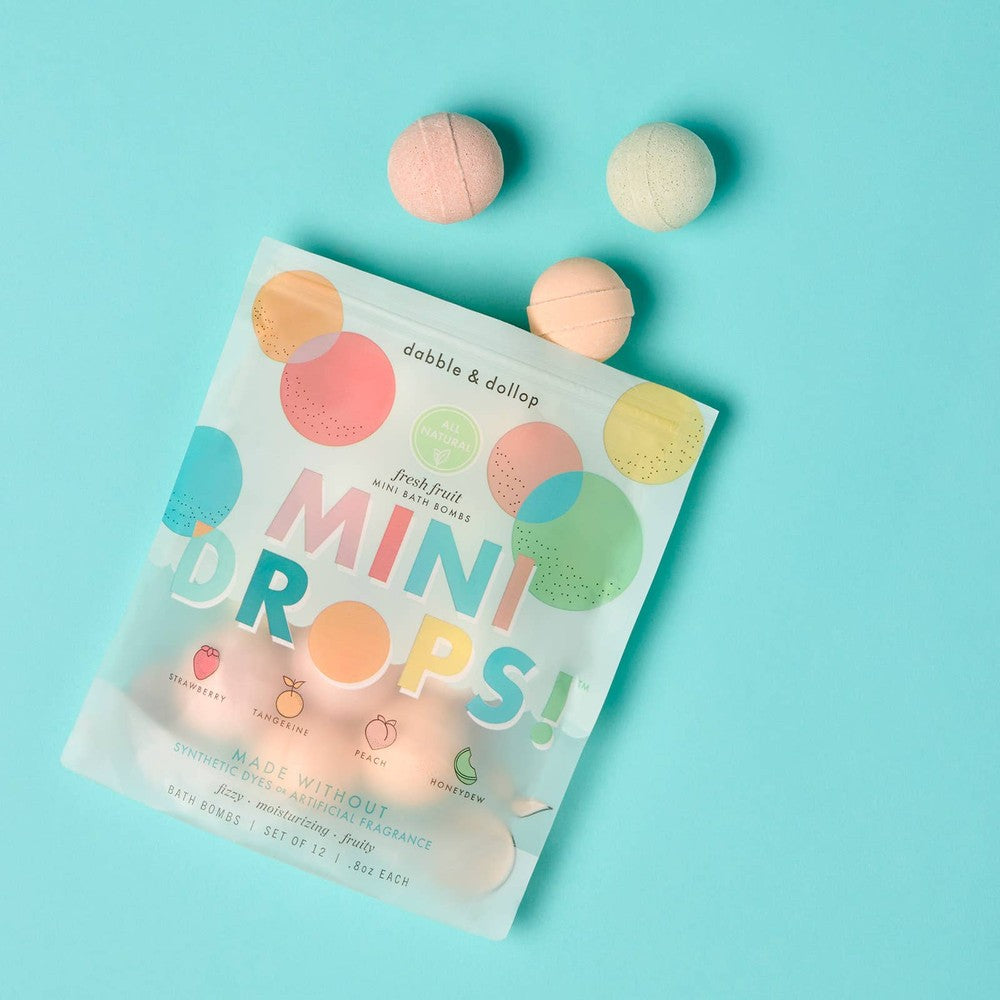 Dabble & Dollop Mini Drops Bath Bombs All-Natural Fresh Fruit, colorful bombs sit around a pastel package.
