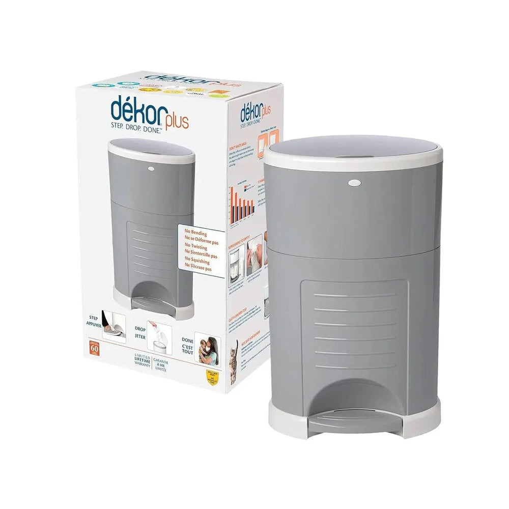 Dekor Plus Diaper Pail in gray with white lid; foot pedal shown for hands-free disposal beside the box.