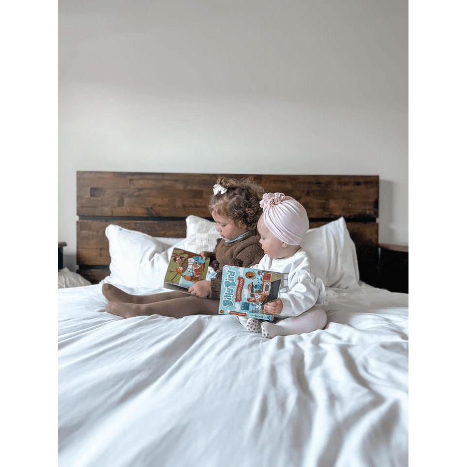 Ditty Bird Sound Book Children's Songs USB-C Rechargeable, two kids sit on a bed reading the educational toy.