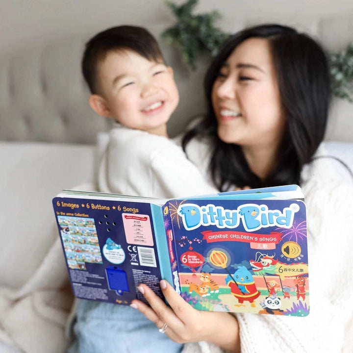 Ditty Bird Sound Book Chinese Songs USB-C Rechargeable with blue cover, read by a smiling mom and child.
