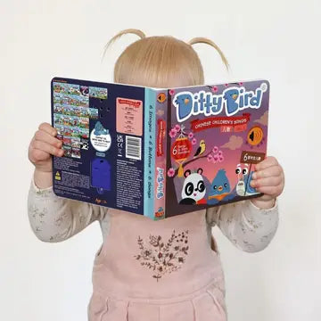 Ditty Bird Sound Book Chinese Songs Vol 2 USB-C Rechargeable held by a child reading the colorful cover.