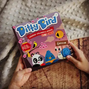 Ditty Bird Sound Book Chinese Songs Vol 2 USB-C Rechargeable, colorful cover held by a child’s hands.
