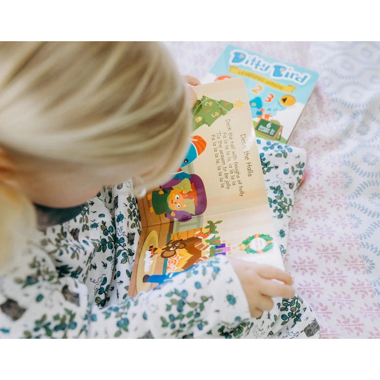 Ditty Bird Sound Book Christmas Songs USB-C rechargeable being read by a child.