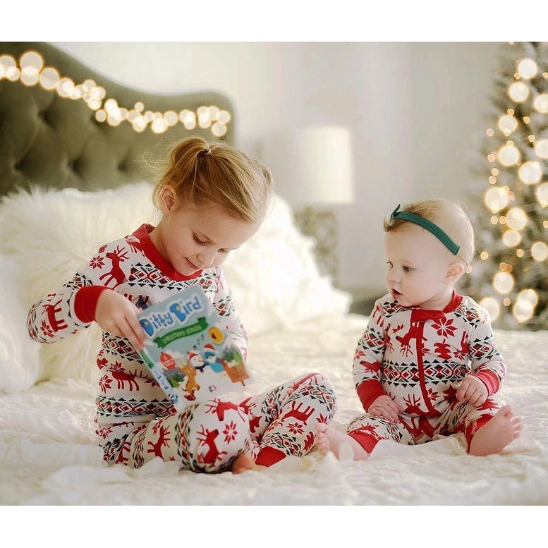 Ditty Bird Christmas Songs sound book being read by two siblings in red-and-white holiday pajamas on a cozy bed.