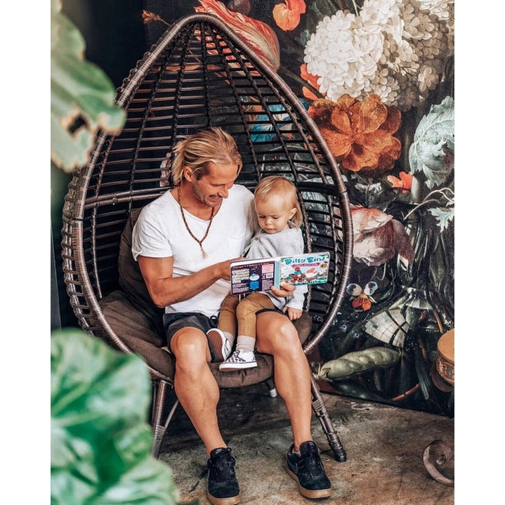 Ditty Bird Sound Book Classical Ballet Music USB-C Rechargeable read aloud to toddler in a cozy hanging chair.