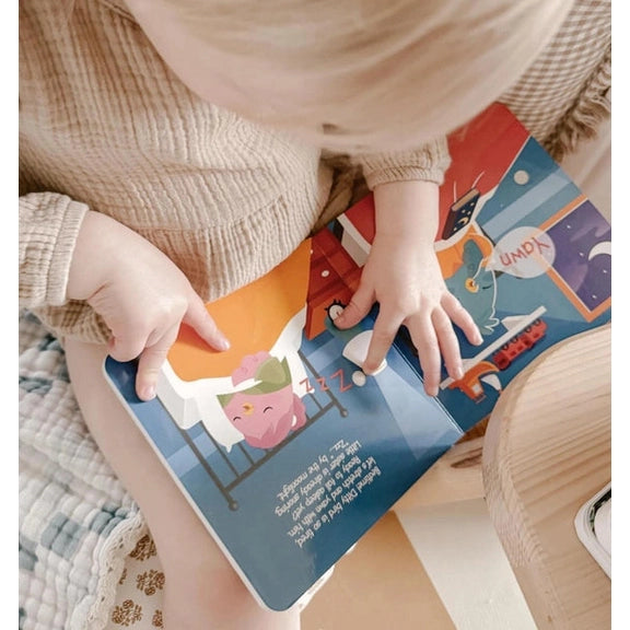 Ditty Bird Sound Book Funny Body Sounds USB-C Rechargeable, toddler turning colorful pages to hear sounds.