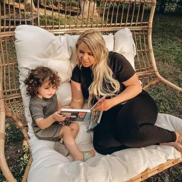 Ditty Bird Sound Book Music to dance to USB-C Rechargeable—mother and child read it together on a sunny outdoor swing.