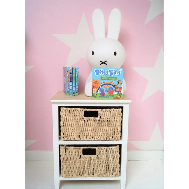 Ditty Bird Sound Book Nature Songs USB-C Rechargeable on a white bedside table beside a plush bunny lamp.