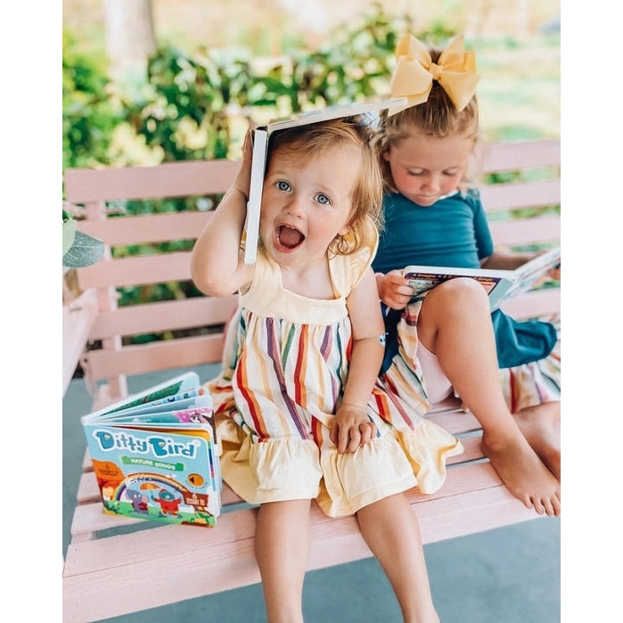 Ditty Bird Sound Book Nature Songs USB-C Rechargeable; two kids enjoy colorful pages on a pink bench.