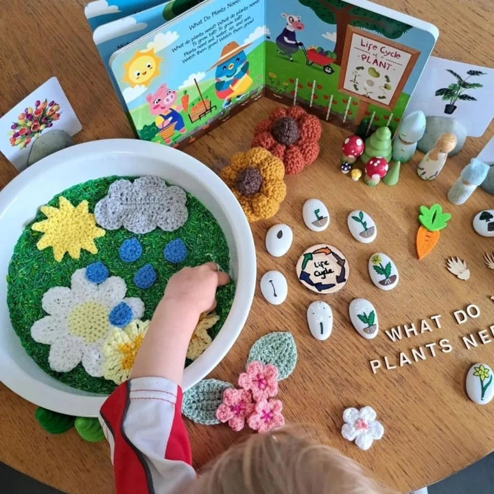 Ditty Bird Sound Book Nature Songs USB-C Rechargeable; a child taps colorful garden pages beside learning cards.