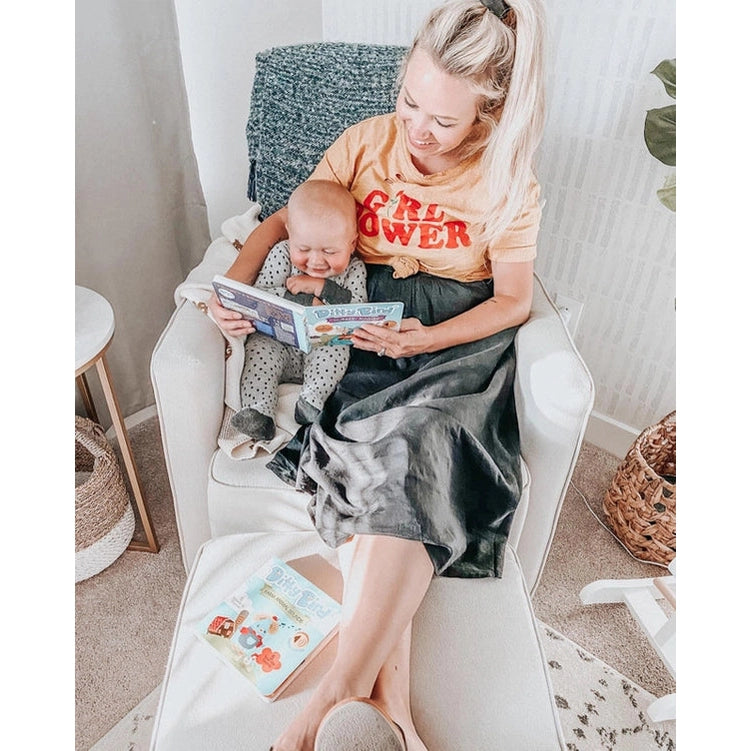 Mother and baby cuddled on a chair reading Ditty Bird Sound Book Nursery Rhymes USB-C Rechargeable, in a cozy living room.