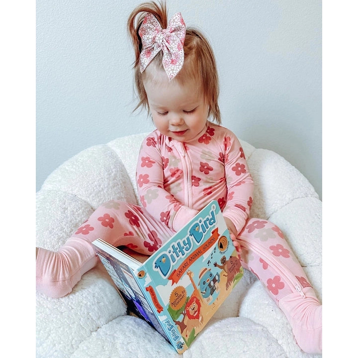 Ditty Bird Sound Book Safari Animal Sounds USB-C Rechargeable read by a toddler in pink floral pajamas.