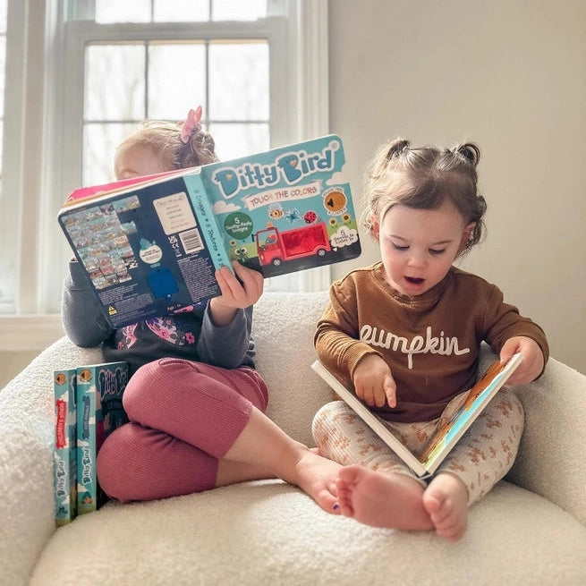 Ditty Bird Sound Book Touch the Colors USB-C rechargeable, two children reading colorful pages on a sofa.