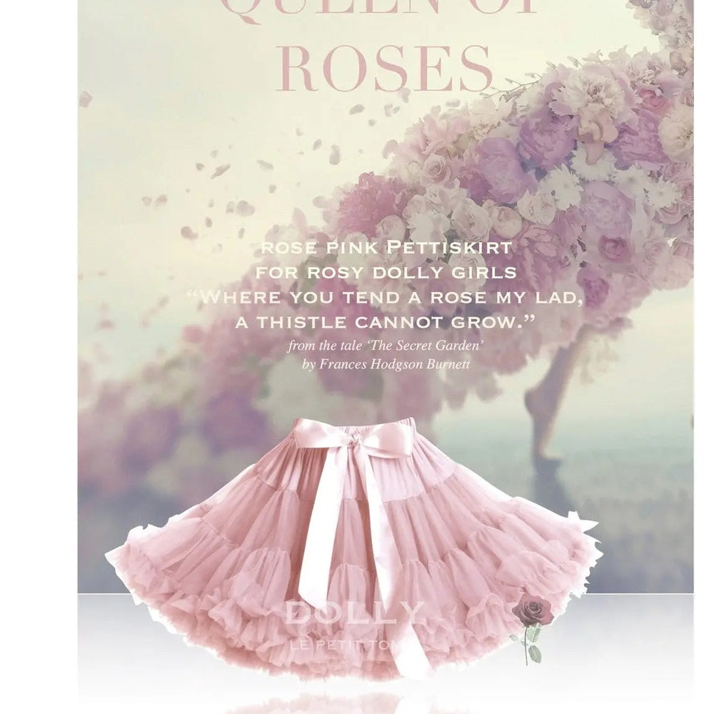 Dolly by Le Petit Tom Queen Of Roses Pettiskirt in rose pink with a pink bow, fluffy ruffled tulle spins on a pastel backdrop.