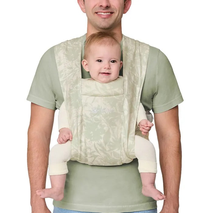 ERGOBABY Embrace Knit Newborn Carrier Sage Meadows worn by parent carrying infant in front.