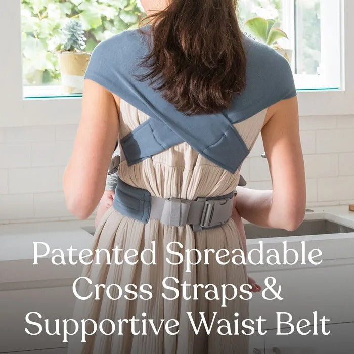 ERGOBABY Embrace Knit Newborn Carrier Sage Meadows worn by parent, showing cross straps and a supportive waist belt in use.