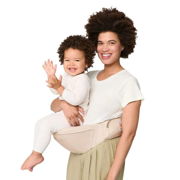 ERGOBABY Lift Hip Seat Baby Carrier Natural Beige carried on hip by smiling mother with baby.