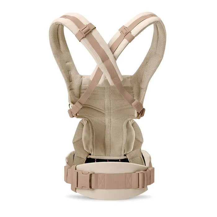 Ergobaby Omni Classic Mesh Baby Carrier Natural Beige worn by a parent, showing cross-shoulder straps and wide padded waist belt.