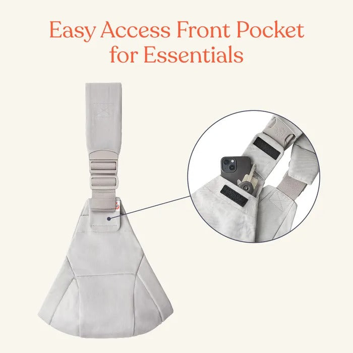 Ergobaby Upsie Sling Carrier in beige with adjustable strap; shows front pocket holding a phone for essentials.